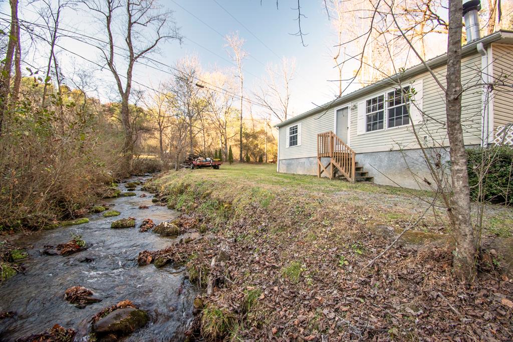 The combination of a nice flowing creek, good amount of fairly level yard and adjoining USFS found at this 2 bedroom 2 bath manufactured home on permanent foundation. Fenced portion of yard for furry friends.