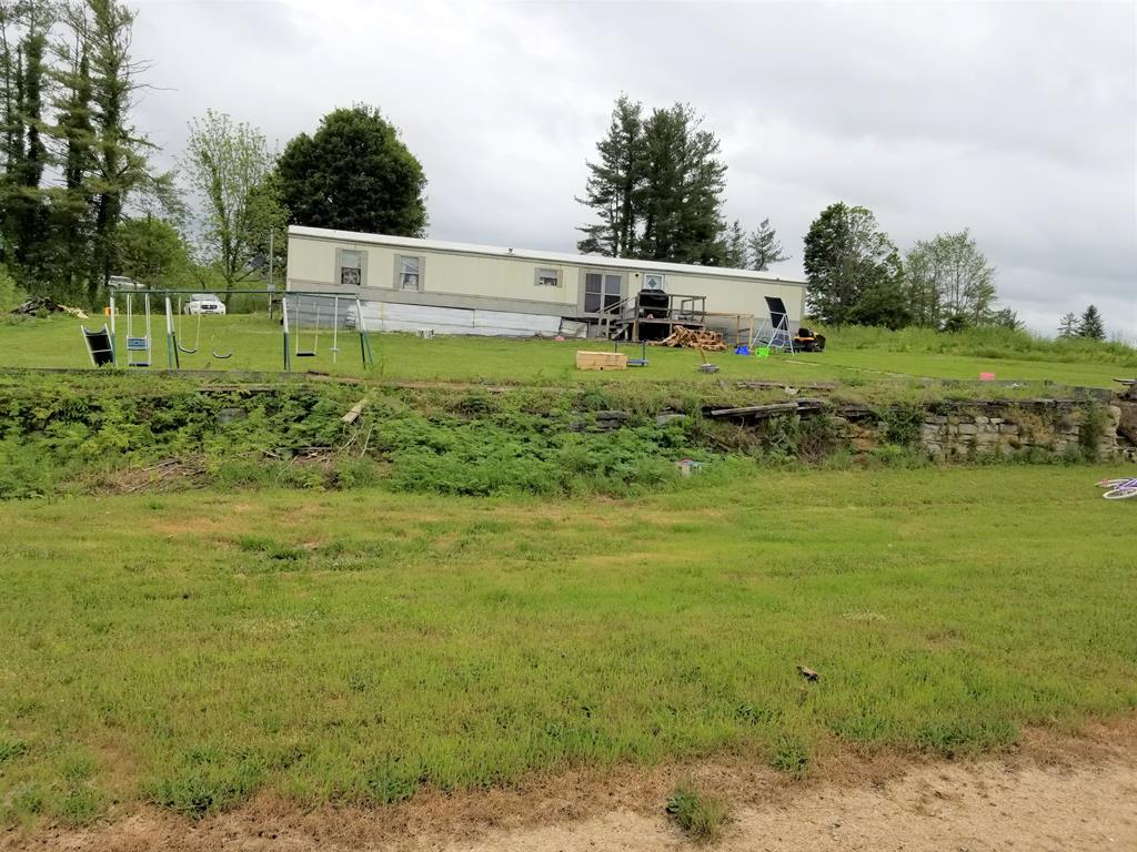 This manufactured home sits on 2.39 acres that backs up to Interstate 81.  When owners bought this property in 2001, it had a large historic home on it.  That home burned down a few years later and they replaced it with this mobile home.  Siding on one of the outbuildings is melted due to that fire.  This property is being sold as-is.  Owner makes no warranties and will make no repairs or concessions..  Buyers and buyer agents should verify all information to their own satisfaction prior to making any offers.  Property is currently rented to a family member for $400 per month.  Tenant will vacate by closing unless new owner is willing to continue to rent to them.
