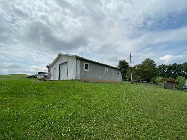 Here is your chance to own a property on Rt 11 that already has a garage/workshop in place.  Property has a garage and walk-in door to the main part.  The back is a workshop area with a walk-in door only.  Great view and would also make a great home site. Electricity is in the building but no heat,well or septic is on the property.