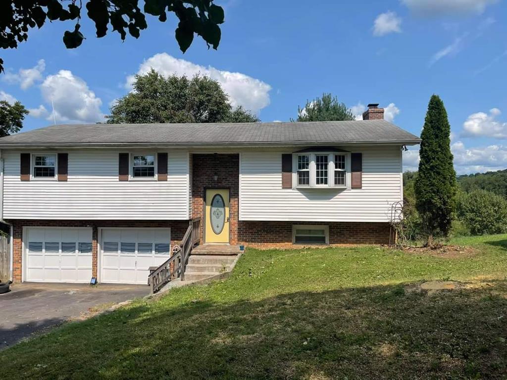 Some updates completed still needs some updates.  Great family home with approx. 1.5 acres, 2 car drive under garage. 3 bedroom, 2 and half bath.  No AC, propane heaters one upstairs and one downstairs.