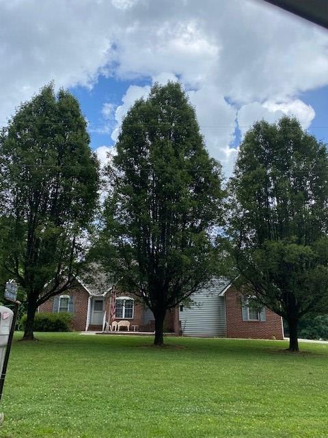 Brick Home with 1390 Heated Sq. Ft. Living Space and a 221 Sq. Ft. Sun Room.  3 Bedrooms and 3 Full Baths.  Full wqlkout Basement.  Large room in basement being used as 4th bedroom with adjoining bath.  There is a storm shelter room and a 2nd laundry in basement.  Home features open LR, Dinning and Kitchen with an adjoining Sunroom.  All rooms have ceiling fans and all bedrooms have double closets.  Master Suite has 2 double closets and adjoining  bath with Safe Step Walkin Tub with Jacuzzi with oxygen air bubbles and underwater jets for that relaxing massage.  Tub also has hand held shower.  2 Car Garage with concrete drive and portable car port and 5 outside storage bulidings. Handicap Ramp and beautiful landscaping.  All Windows in home are doubled paned.  Hardwood, carpet and vinyl floors.  Wood stove in basement tierdf into duct work.