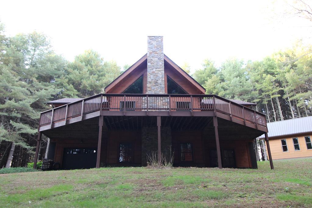 The ultimate in privacy/seclusion custom 3 bed/3 bath Southland Log Home on 17 magical wooded acres, full pond plus separate ENORMOUS 4 car capable detached garage w/lean-to shed, plus a 16x24 separate she-shed w/power/lights can serve as home school or workshop. The land surrounding this secluded log cabin home is all easy on the legs, trails all over it, views are just fantastic from the rear open deck that wraps around the back of the home. The full span front covered porch is a place of peace & serenity.. nothing but the breeze through the trees & the deer that live here too. The pond and natural berries are the gathering place just below the log home for turkey & deer to sip and graze. The main floor is wide open, bright, airy and each room just flows into the next. Master on main w/new custom bath & walk in closet is perfect. Master bed opens out to the rear deck. Blue Ridge Mountain Living at its finest. This place has it all. Meticulously maintained and recently redone for you.