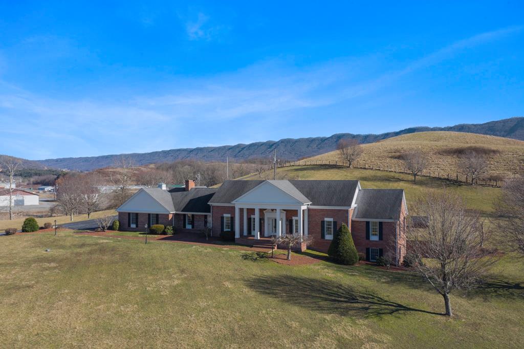 Located in Tazewell County, VA, within close proximity to the Back of the Dragon and 15-20min to Bluefield, this stately manor home sits on 15 acres of land and offers primarily one level living. You will find 3 bedrooms and 3 full bathrooms, a large eat-in kitchen, separate dining room, living room & an office/den all on the main floor. A 4th full bath, several utility or storage rooms, laundry and great room are located in the basement. Outside, find a wonderful open patio for entertaining, gorgeous property views and an oversized 2 car attached garage. In addition, an income producing, well kept 1972 doublewide, with 3 bedrooms & 2 baths is also included. Additional acreage with a 3 bedroom, 1 bathroom income producing home & a 4000sq feet 4 bay garage is also available and is being sold separately, see MLS #80656 for more information. Main home with doublewide must sell first.