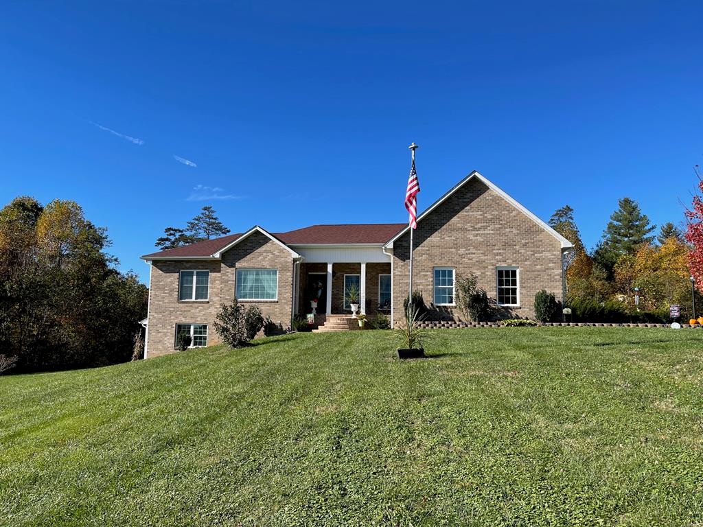 Beautiful quality custom built brick home within 5 miles to I-77 in Hillsville. Home features: 3 BR, 2.5 BA, 2244 sq. ft. 10' ceilings, hardwood and tile flooring throughout, main level living with a spacious living room with 13' ceilings, family room, dining room, kitchen with custom cabinets, granite counter tops and appliances conveying, office, master bedroom with a sitting area, master bath, 2 more bedrooms, bath, half bath and laundry. Double doors that go out to a private deck. Open deck with an umbrella conveying & handicap accessible. A stylish front covered porch to enjoy the country side views. 2 car garage with a large space overhead for storage. On the lower level you have 2244 sq. ft. unfinished with easy access that includes a lift chair or use the outside entrance.  Plumbed for another full bathroom and could be easily finished or just use for a workshop/storage. Land features: Country side views, 2 acres and level to sloping land.