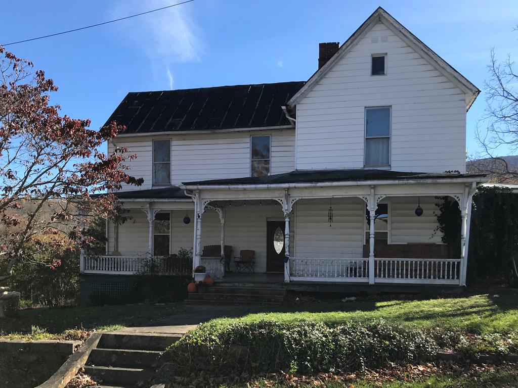 JUST REDUCED $6,250 and RELISTED WITH LOCAL AGENT.THIS HOMEOWNER IS MOTIVATED TO SELL.  BRING OFFERS!  Local residents will remember this spacious home as the Jeff Ward home. For someone looking at this listing from out of the area, it is located in the charming and much loved historic district of Tazewell.  The seller loves this home and is only selling mid remodel for health reasons and to relocate nearer to her family Here is your opportunity to own a piece of local history.This home needs a little bit of TLC, but it has amazing old bones.  Recent contractors have been in awe of original construction.  Need a bedroom on the first floor?  Perfect, this home has one and another 4 upstairs. Now let's talk about the exquisite woodwork, much of which is original.You like original hardwood floors? This home has them! Get ready to fall in love with the front porch and it's intricate railing.The kitchen has been updated, and there are  laundry facilities on the main floor. Seven new windows