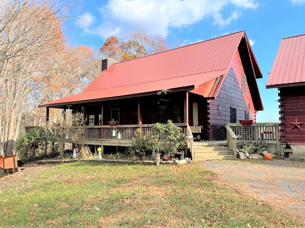 Quality built Log Cabin with a gated entrance on 20.99 acres. Home features: 3348 sq. ft., 2 BR, 2 BA and 2 half baths. On the main level you have a living room with a floor to ceiling stone fireplace with insert, kitchen with all appliances conveying, 12' x 48' side deck with a wood burning fireplace & a screened in back porch, master bedroom with walk-in closet, master bath with tub/shower, laundry room and half bath combined. On the upper level you have a large loft, full bath and another bedroom with a huge closet. On the lower level you have a family room with a bar area & stools, half bath, a sewing/craft room and a spacious open deck. Home has trex decking, poured concrete basement walls, metal roof, heat pump, pella windows and tankless water heater. Home has an attached 30' x 40' garage with an oil stove & freezer conveying and a 14' x 40' unfinished room overhead.