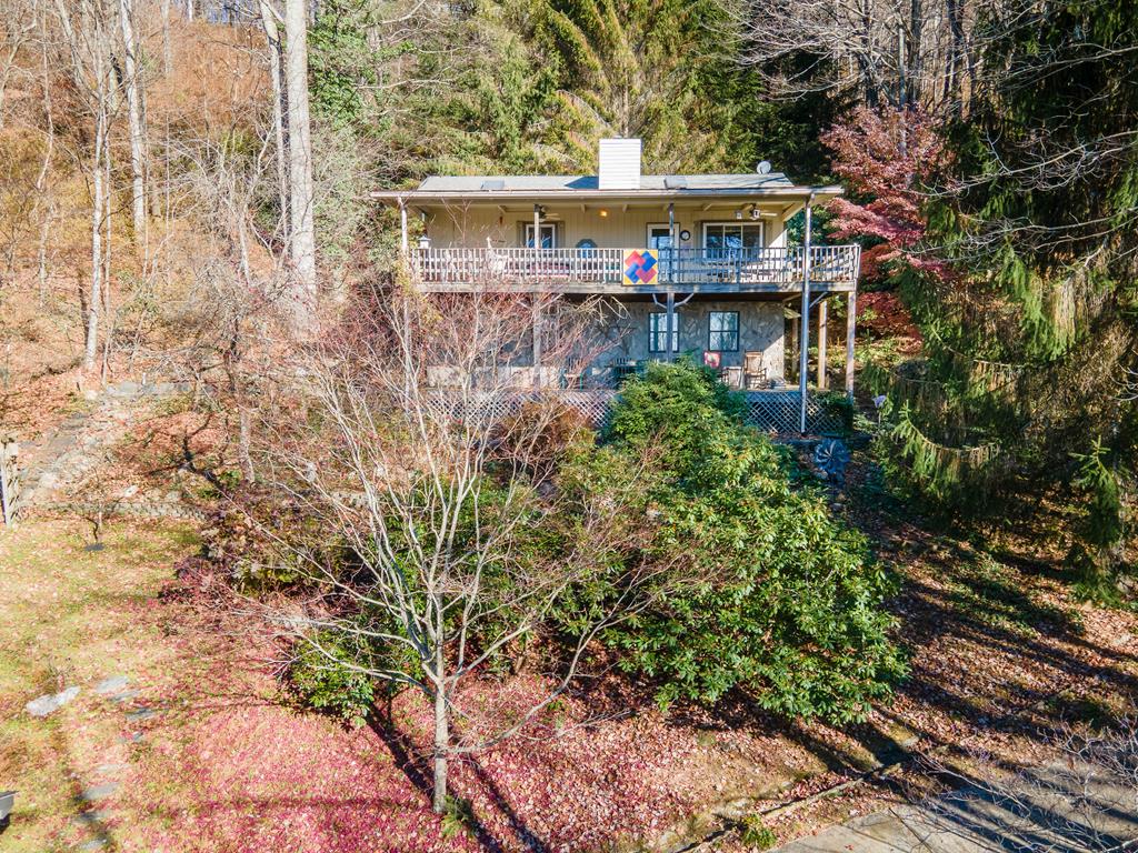 Beautiful well maintained Mountain home in picturesque Floyd County. Enjoy the peaceful woodland setting in a quiet, dog friendly community with walking trails less than a mile from the Blue Ridge Parkway. Plenty of outdoor living space with long range winter views. Beautifully landscaped with hydrangea, wisteria, jasmine clematis, rhododendron, mountain laurel, ornamental trees and countless perennials. Shed/Studio is insulated. Great location for yourself or your guests to enjoy the Blue Ridge Mountains and all that Floyd has to offer. 10 minutes to Mabry Mill andChateau Morrisette. 35 minutes to Primland and only 25 minutes to downtown Floyd. Property sells AS-IS. Adjacent acre is available for sale separatelyMLS 413637