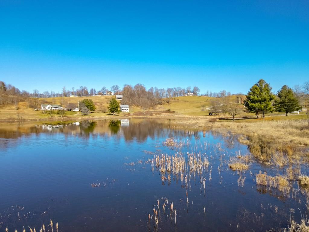 This 2.27 acres are gently sloped, and would not be difficult to put a driveway in and build your dream home. The main attraction here is the deeded access you have to the private lake, which is over 9 acres in size. The pond also has a picnic shelter available for lot owners. The location is just 5 miles to the grocery store in Independence, and conveniently located to hiking trails, trout fishing, and state and national parks. There are equestrian trails around also. You have the perfect location for the avid outdoors person. This acreage consists of two lots. You are just 30 minutes to Galax, and 40 minutes to Wytheville. You are also just an hour and a half to Winston Salem, NC. This is a nice opportunity to get in cheap before the area's growth increases the values of property! Road and common area maintenance fees are just $200 per year. Very gentle covenants and restrictions.