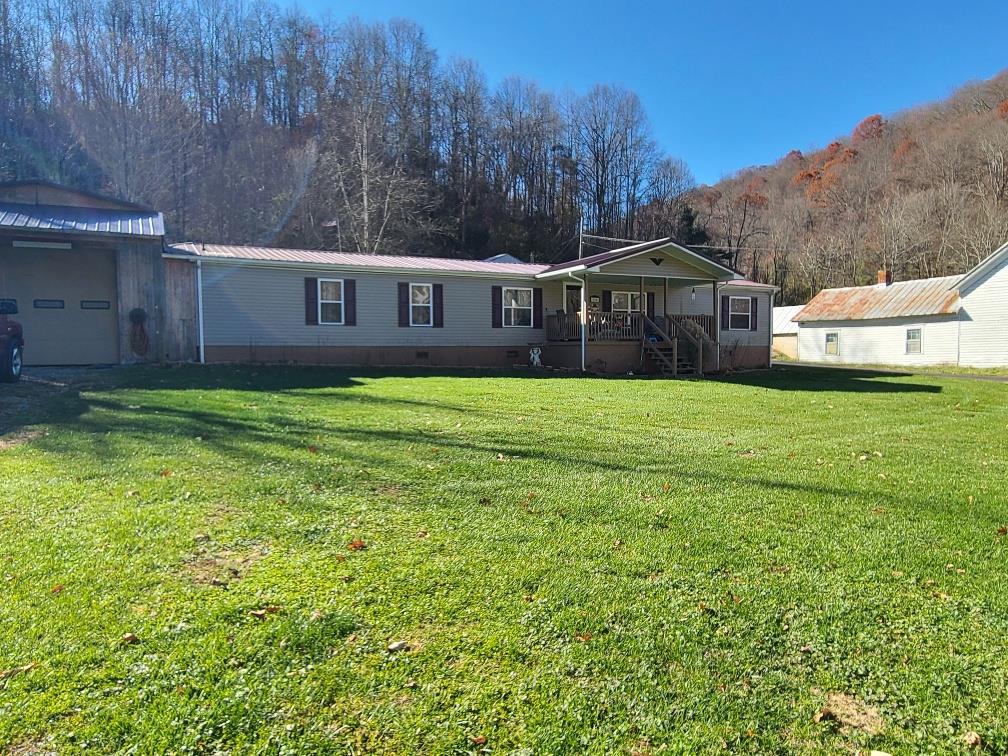 Spacious 4 BR, 3 BA doublewide with several outbuildings, garage, and large carport.  Newer vinyl siding, newer insulated windows, newer floor covering and new heat pump.  Located within 1 mile of I-81.