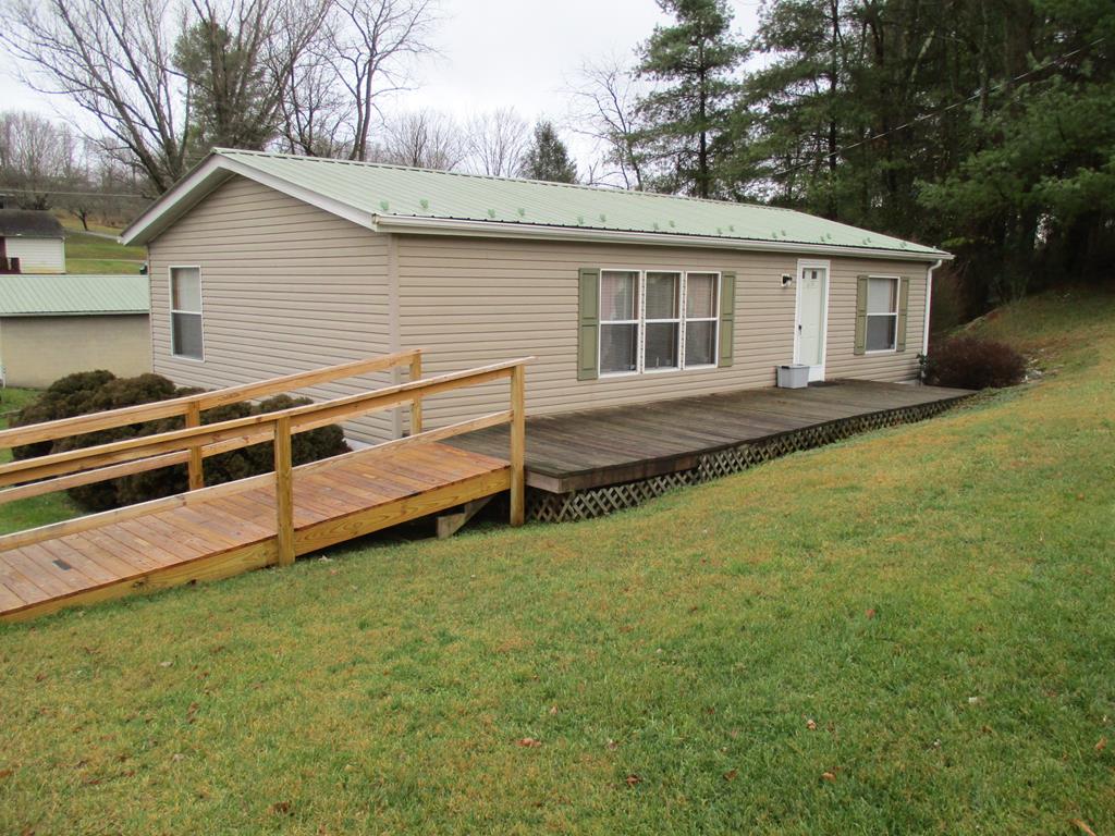 Well maintained ready to move into  2 bedroom, 2 bath home on permanent foundation. Great entertaining on large covered deck. Metal roof 2013, paved driveway leads to a detached 2 car/workshop. Why rent when you can own your own home.