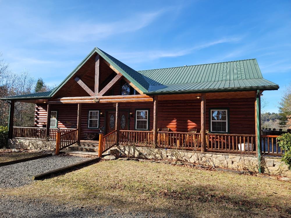 Public Remarks: Custom built log home on 5+ private acres in the Blue ridge Mountains of Southwest Virginia and located within walking distance of the Jefferson National forest! This well-built cabin comes fully furnished with high end furnishings and features include: main level 4 bedroom 2 full baths, vaulted ceilings, stone wood burning fireplace, spacious open floor plan with hardwood & tile flooring throughout, wrap-around porch with covered back deck. Lower level has large family room, wet bar, pool table, 2 bedrooms, full bath and 2- car garage. Land is mostly wooded offering seclusion, natural landscaping, several fruit trees and much more. Within minutes  to the Jefferson National Forest, New River and The New River Trail which is 57 miles long and some of the best trout fishing Carroll County has to offer.